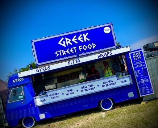 Bright blue Greek street food truck.