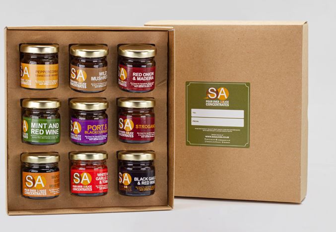 image of 9 small jars of assorted sauce concentrate in presentation box